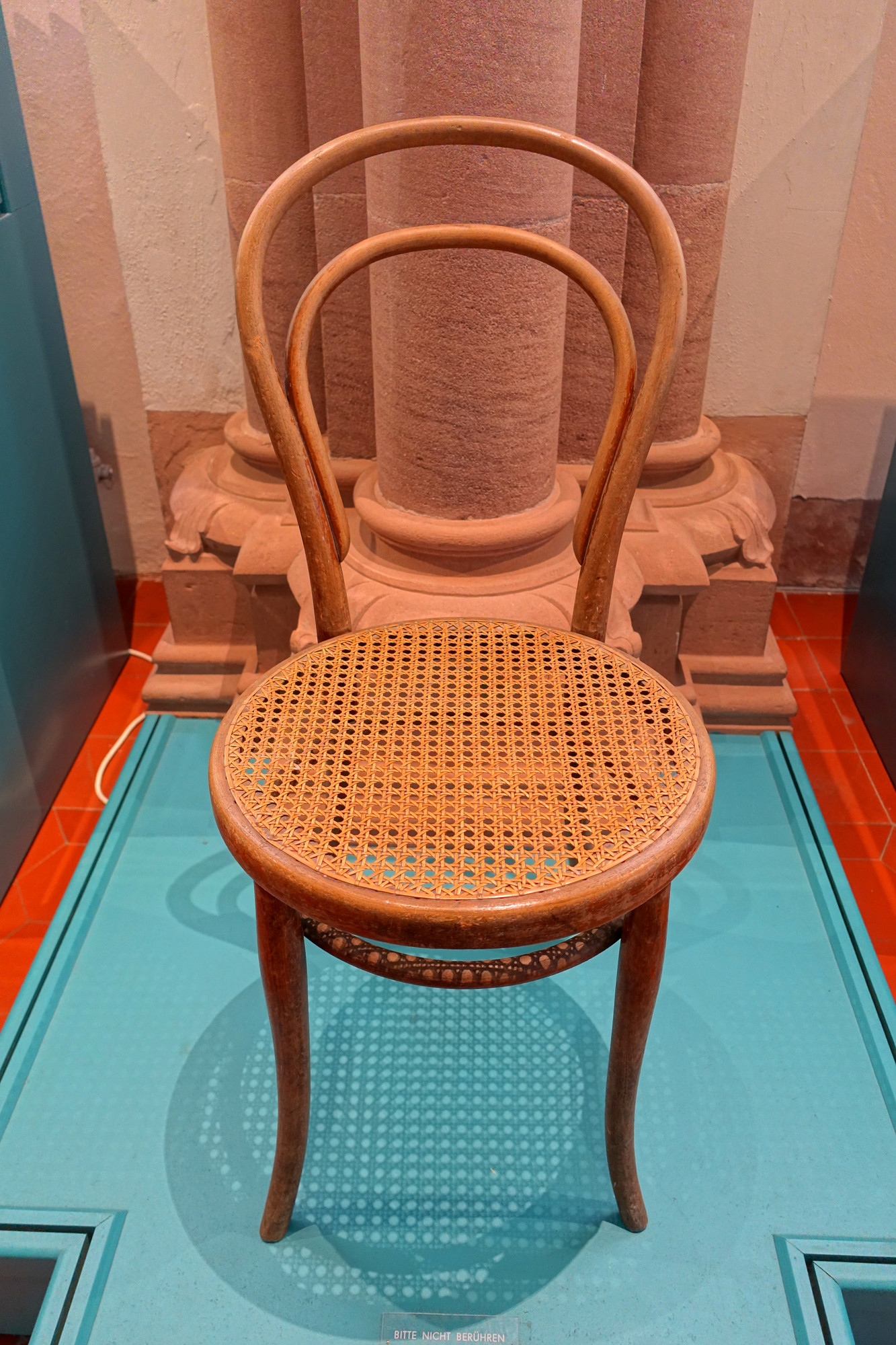 A circa-1920 Thonet Chair No. 14 museum example with a bent beech loop back, slender legs and woven cane seat.
